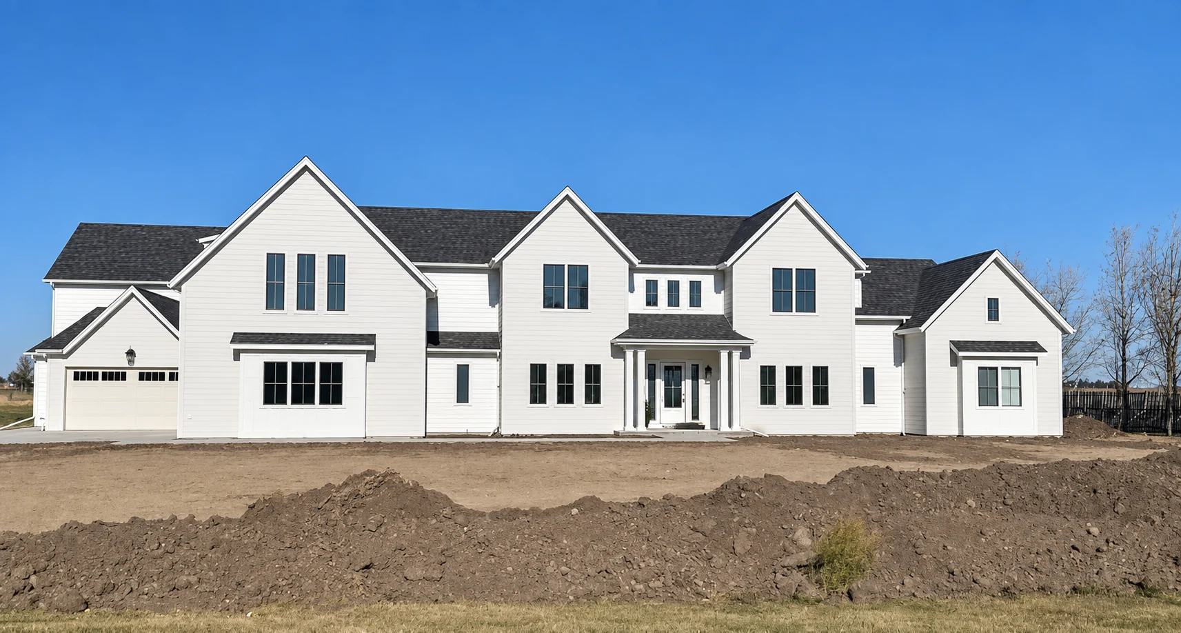 White Anfield home with multiple gables, dark rooflines and a central covered entrance