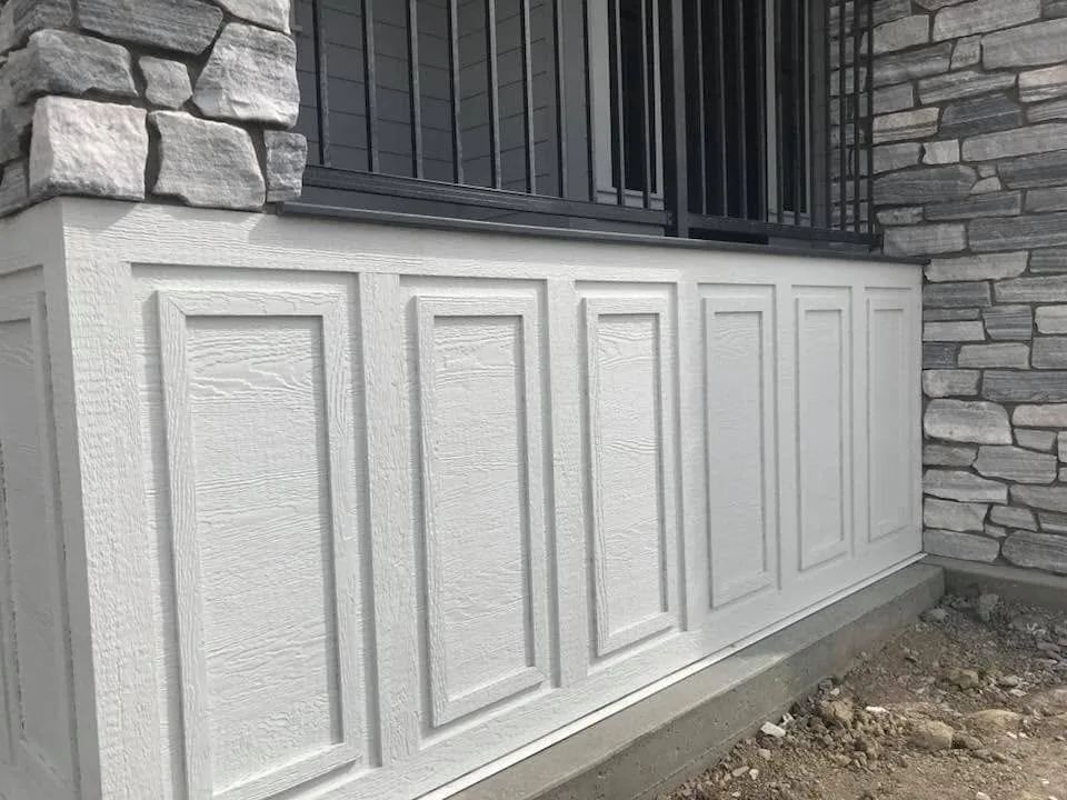 Panelled porch skirting beside stacked stone