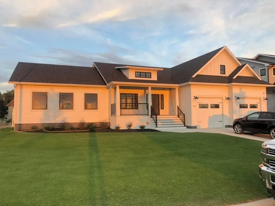 Completed bungalow in warm evening light with a covered entrance and landscaped lawn