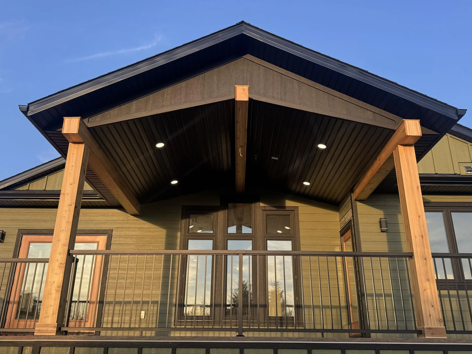 Completed covered porch with substantial timber posts and a gabled timber ceiling