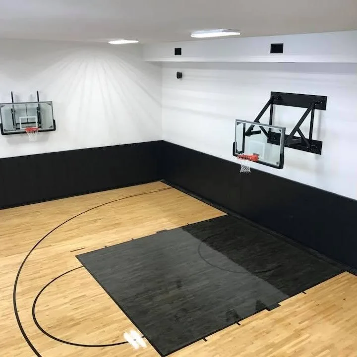Indoor basketball court with two hoops and a hardwood floor